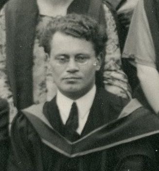 Black and white photograph of Philip Leon wearing academic dress and spectacles.