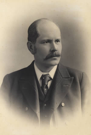 Black and white photograph of C. J. Bond wearing suit and tie.