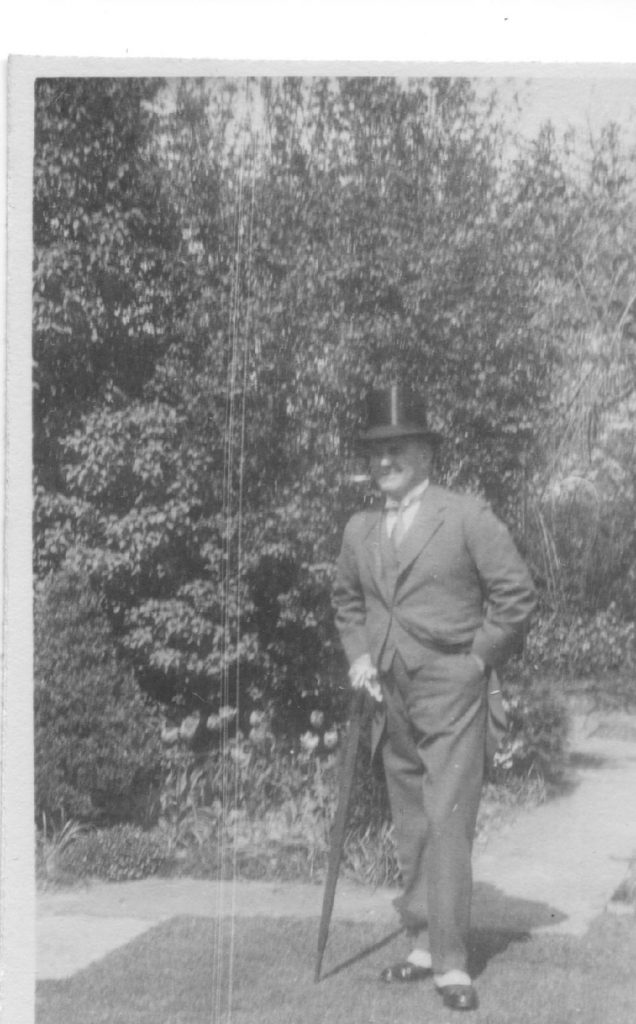 Black and white photograph of Dr Astley Clarke wearing a top hat.