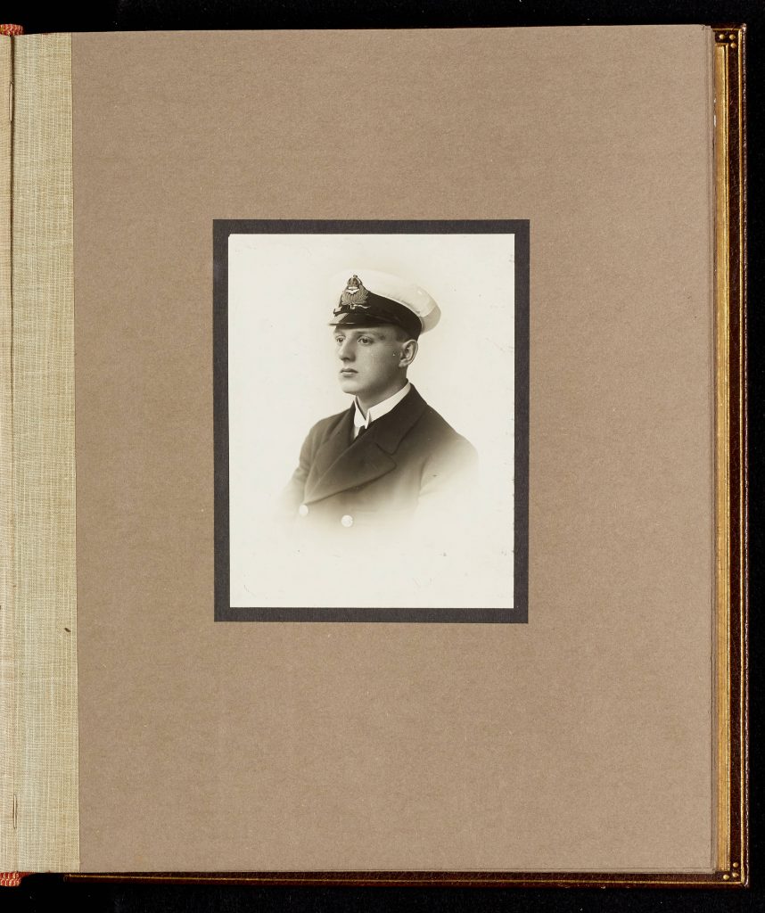 Mounted black and white photograph of Oliver Bernard Ellis from University of Leicester memorial portraits book. Ellis is wearing naval uniform.