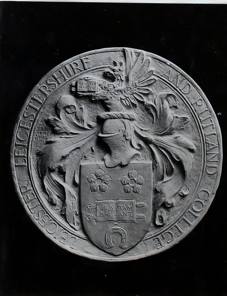 Black and white photograph of the coat of arms of Leicester, Leicestershire and Rutland College