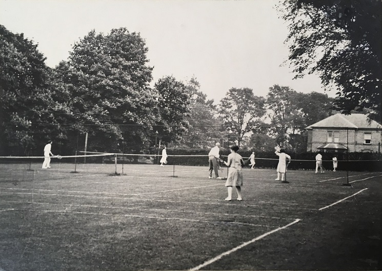 Black and white photograph of students using the University College tennis courts, near College House, c.1929, a photograph in the University of Leicester Archives, ULA/FG1/3/12